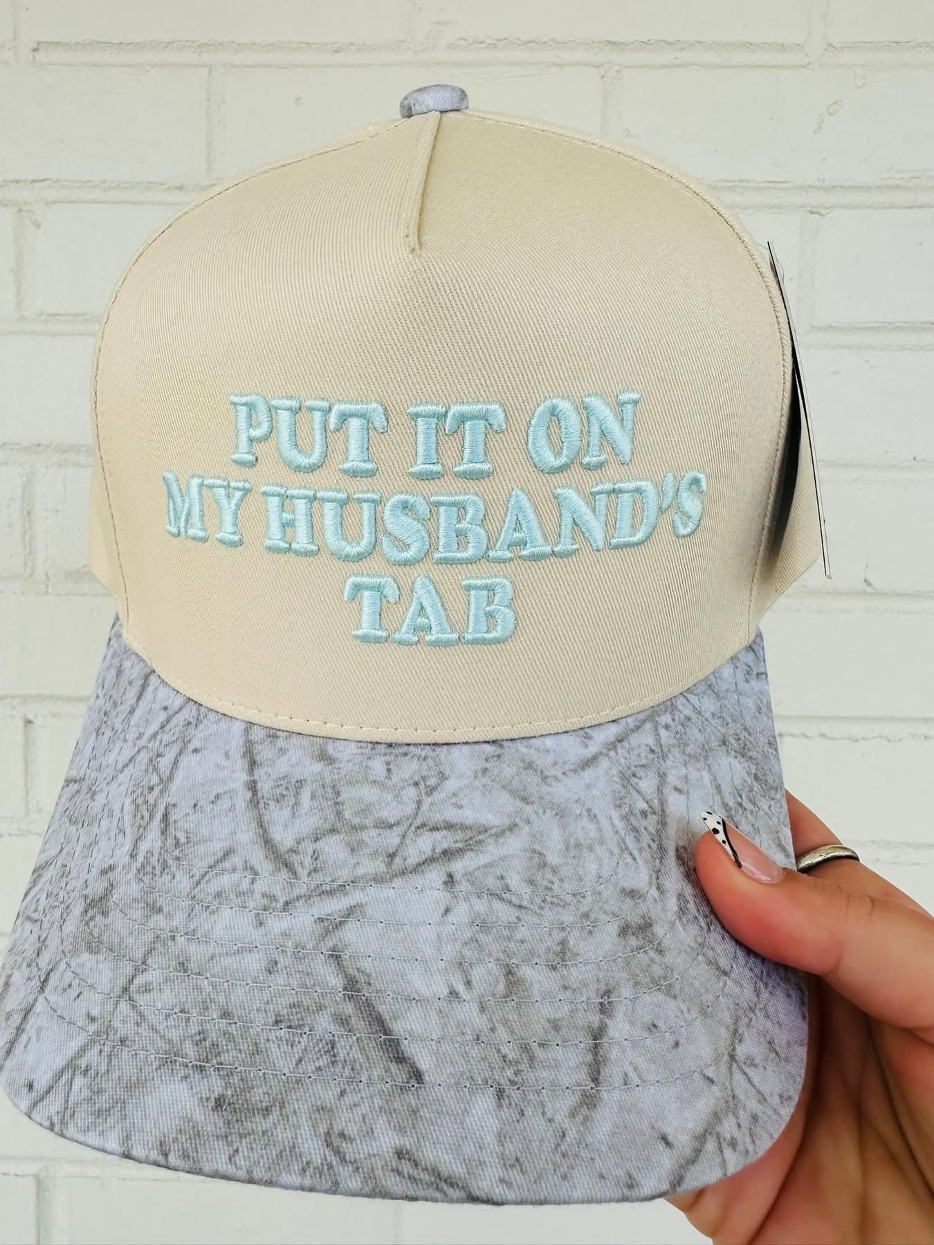 PUT IT ON MY HUSBAND'S TAB Trucker Hat